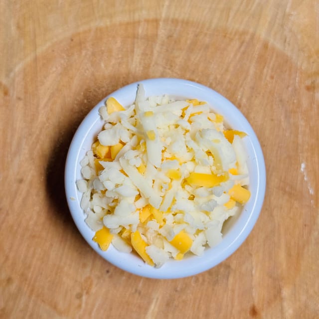 Side of shredded cheese.